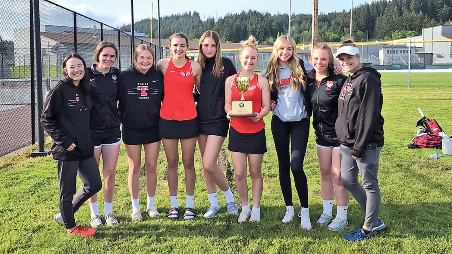 The Tenino girls tennis team poses with the 1A District 4 championship trophy after winning the team title at the District 4 girls tennis tournament Tuesday in Chehalis.